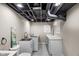 Basement utility area features laundry sink, modern fixtures, and ample counter space at 7999 Englewood Rd, Indianapolis, IN 46240