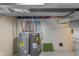 Basement area featuring two water heaters with exposed ceiling and brick walls at 7999 Englewood Rd, Indianapolis, IN 46240