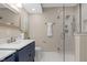 Stylish bathroom with a glass shower door, blue vanity with a modern sink, and tile flooring at 7999 Englewood Rd, Indianapolis, IN 46240