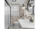 Bright bathroom featuring a white vanity, updated fixtures, glass-enclosed shower, and ample natural light at 7999 Englewood Rd, Indianapolis, IN 46240