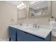 Chic bathroom features double sinks with blue vanities, modern faucets, and a large mirror at 7999 Englewood Rd, Indianapolis, IN 46240