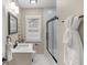 This modern bathroom features a vanity, framed mirror, and tiled shower at 7999 Englewood Rd, Indianapolis, IN 46240