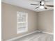 Unfurnished bedroom with neutral carpet, ceiling fan, and a window bringing in natural light at 7999 Englewood Rd, Indianapolis, IN 46240