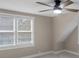 Calm bedroom with ceiling fan, neutral walls, carpet, and a window with natural light at 7999 Englewood Rd, Indianapolis, IN 46240