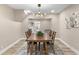 This dining room features wood floors and a wooden table at 7999 Englewood Rd, Indianapolis, IN 46240
