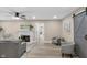Open-concept living room with hardwood floors, neutral walls, a fireplace, gray sofa, and natural light streaming in at 7999 Englewood Rd, Indianapolis, IN 46240