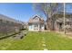 Quaint backyard showcasing a cozy firepit, garden beds, and lush green grass at 831 Weghorst St, Indianapolis, IN 46203