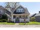 Charming blue two-story home with inviting front porch and well-maintained lawn at 831 Weghorst St, Indianapolis, IN 46203
