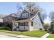 Blue home exterior featuring a inviting front porch, well kept lawn, and nearby houses at 831 Weghorst St, Indianapolis, IN 46203