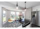 Granite kitchen island with cooktop and views from bay window at 831 Weghorst St, Indianapolis, IN 46203