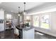 Kitchen island with cooktop and bar seating near windows at 831 Weghorst St, Indianapolis, IN 46203