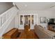 Open-concept living room with hardwood floors, white columns, and a view of bathroom at 831 Weghorst St, Indianapolis, IN 46203