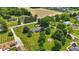 Expansive aerial view of a well-maintained property with mature trees, fire pit and generous lawn space at 8510 N Carroll Rd, Indianapolis, IN 46236