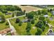 Beautiful aerial perspective of a home enveloped by lush trees with a fire pit feature at 8510 N Carroll Rd, Indianapolis, IN 46236