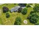 Expansive aerial perspective of a home with a detached garage and a unique outdoor firepit and seating area at 8510 N Carroll Rd, Indianapolis, IN 46236