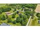 Aerial view of a home surrounded by lush greenery, mature trees and a large lawn at 8510 N Carroll Rd, Indianapolis, IN 46236