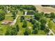 Scenic aerial shot showcasing a lovely home with a fire pit, surrounded by mature trees and greenery at 8510 N Carroll Rd, Indianapolis, IN 46236