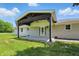 Inviting back patio with dark wood beams, ceiling fan, and concrete flooring for outdoor living at 8510 N Carroll Rd, Indianapolis, IN 46236