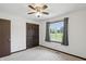 Bedroom featuring carpet, a closet, a fan, and a large window providing plenty of natural light at 8510 N Carroll Rd, Indianapolis, IN 46236