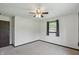 Bedroom featuring carpet, a closet, a fan, and a large window providing plenty of natural light at 8510 N Carroll Rd, Indianapolis, IN 46236