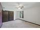 An empty bedroom with neutral carpeting, a fan, a closet, and a window at 8510 N Carroll Rd, Indianapolis, IN 46236