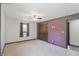 Bedroom with tan carpet, ceiling fan, and neutral colored walls at 8510 N Carroll Rd, Indianapolis, IN 46236