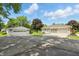Charming property showcasing a detached garage, spacious driveway, and well-maintained landscaping at 8510 N Carroll Rd, Indianapolis, IN 46236