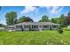 Attractive ranch-style home with a detached garage, mature trees, and a lush front lawn at 8510 N Carroll Rd, Indianapolis, IN 46236