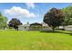 Rear view of a house with a large backyard and covered patio at 8510 N Carroll Rd, Indianapolis, IN 46236