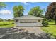Detached two-car garage with white siding and flower boxes, set on a large lot at 8510 N Carroll Rd, Indianapolis, IN 46236
