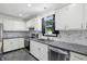 Kitchen with stainless steel appliances, white cabinets, and stone countertops at 8510 N Carroll Rd, Indianapolis, IN 46236