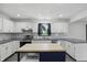 Bright kitchen featuring white cabinets, stainless appliances, and a marble backsplash at 8510 N Carroll Rd, Indianapolis, IN 46236