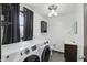 Laundry room features a sink, front load washer and dryer, and a window at 8510 N Carroll Rd, Indianapolis, IN 46236