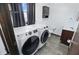 Laundry room featuring front load washer and dryer, utility sink, and storage cabinet at 8510 N Carroll Rd, Indianapolis, IN 46236