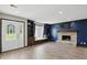 Inviting living area featuring a stone fireplace, built-in shelves, and a large window at 8510 N Carroll Rd, Indianapolis, IN 46236