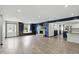 Bright and spacious living area with fireplace, built-in shelving, and access to kitchen at 8510 N Carroll Rd, Indianapolis, IN 46236
