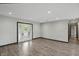 Bright living room with wood floors, white walls, and french doors to the outside at 8510 N Carroll Rd, Indianapolis, IN 46236