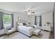 Bright main bedroom featuring neutral décor, ceiling fan, ensuite access, and plenty of natural light at 8510 N Carroll Rd, Indianapolis, IN 46236