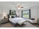 Bright main bedroom featuring a large bed, bench, and multiple windows at 8510 N Carroll Rd, Indianapolis, IN 46236