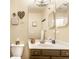 Well-lit bathroom with a neutral color scheme, decorative mirrors, and updated fixtures at 9263 Wadsworth Ct, Fishers, IN 46037