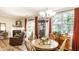 Open dining area with a wooden table, chairs, and views into the living room at 9263 Wadsworth Ct, Fishers, IN 46037