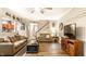 Open-concept living room with hardwood floors, comfortable seating, and stairs leading to upper floor at 9263 Wadsworth Ct, Fishers, IN 46037