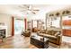 Bright living room with hardwood floors, ceiling fan, comfortable seating, and access to the backyard at 9263 Wadsworth Ct, Fishers, IN 46037