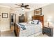 Cozy main bedroom with a ceiling fan, warm lighting, and traditional furnishings at 9263 Wadsworth Ct, Fishers, IN 46037