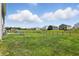Backyard with a plush lawn, dark fence, and beautiful sky view at 9537 Crossfield Rd, Avon, IN 46123