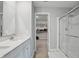 Bright bathroom featuring dual sink vanity with stone countertop and a walk-in closet in background at 9537 Crossfield Rd, Avon, IN 46123
