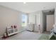 Bedroom featuring carpet floors, gray walls, a window view and shelving with books at 9537 Crossfield Rd, Avon, IN 46123