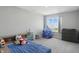 Bright bedroom featuring a window view, blue accent and carpet floors at 9537 Crossfield Rd, Avon, IN 46123