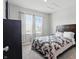 Bright bedroom featuring two large windows, a cozy quilt, and neutral walls at 9537 Crossfield Rd, Avon, IN 46123