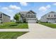 Traditional two-story home with a pristine lawn and an extended driveway at 9537 Crossfield Rd, Avon, IN 46123